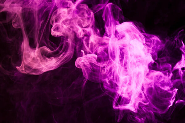 Dense multicolored smoke of pink and purple colors on a black isolated background. Background of smoke vape