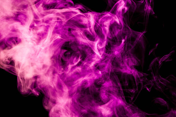 Colorful pink and red smoke on a black isolated background. Background from the smoke of vape