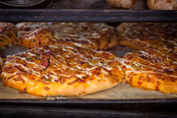 A close-up of the process of cooking pizza in the oven at a high temperature in a bakery