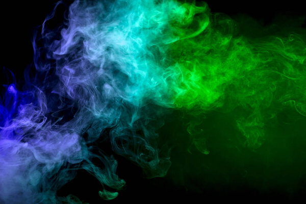 Colorful blue and green smoke on a black isolated background. Background from the smoke of vap