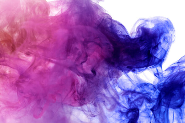 Thick pink and blue  colorful smoke  on a black isolated background. Background from the smoke of vap