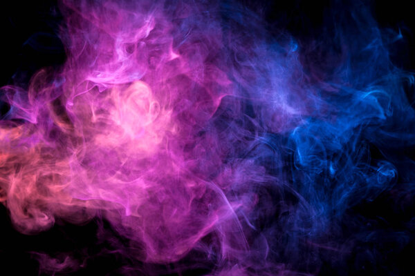 Thick pink and blue colorful smoke on a black isolated background. Background from the smoke of vap
