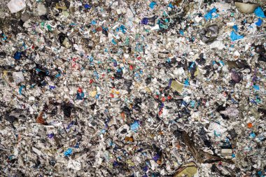 Environmental pollution. Aerial top view photo from flying drone of large garbage pile. Garbage pile in trash dump or landfill.  clipart