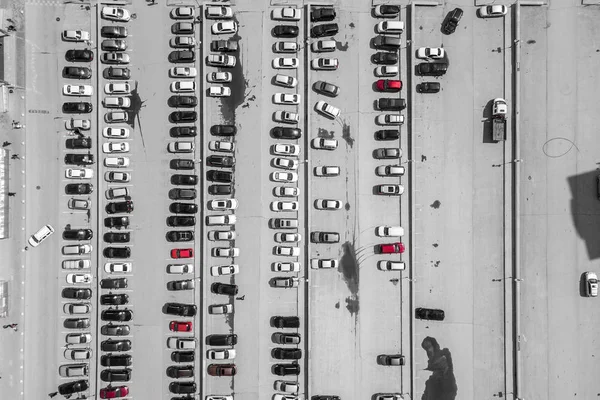 Aerial top view of parking lot with many cars from above, transportation and urban concept. Helicopter drone shot.