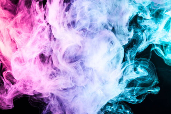 Pink, blue and red cloud of smoke of black isolated background. Background from the smoke of vape