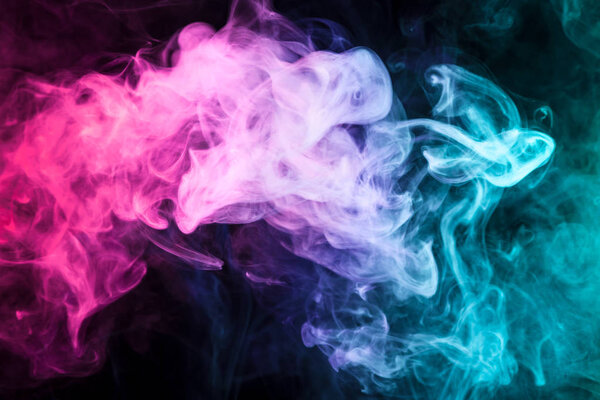 Pink, green and blue smoke on black background