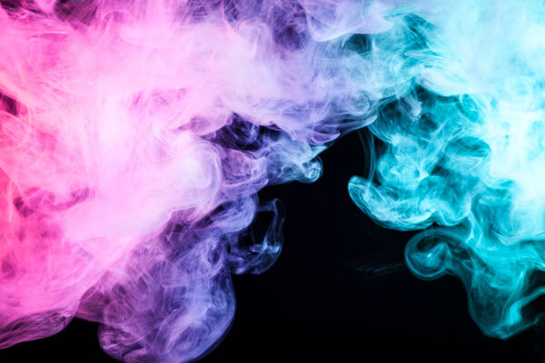 Pink, blue and green smoke on black background