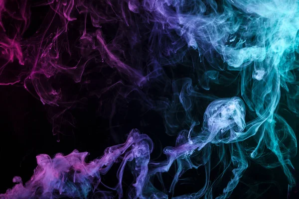 Blue, red  and pink  cloud of smoke of  black isolated background. Background from the smoke of vap