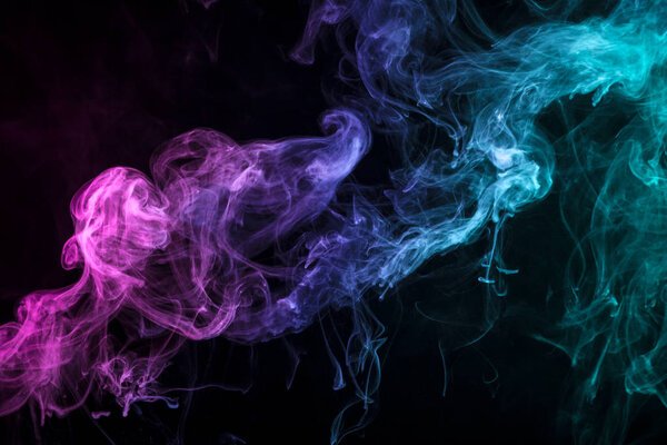 Colorful blue, pink and red smoke on a black isolated background. Background from the smoke of vap