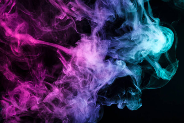 Colorful blue, pink and red smoke on a black isolated background. Background from the smoke of vap