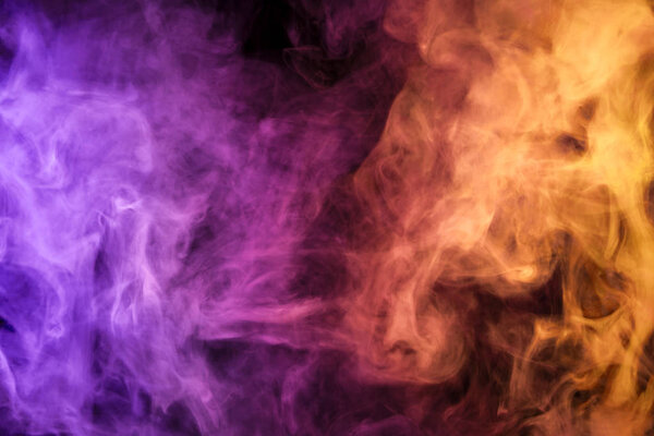 Colorful pink and orange smoke on a black isolated background. Background from the smoke of vap