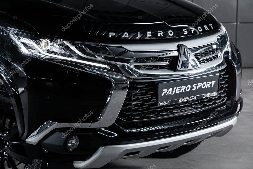Novosibirsk, Russia  September 18, 2019:  Mitsubishi Pajero Sport, close-up of the headlight, bumper, wheel. Photography of a modern car on a parking in Novosibirsk