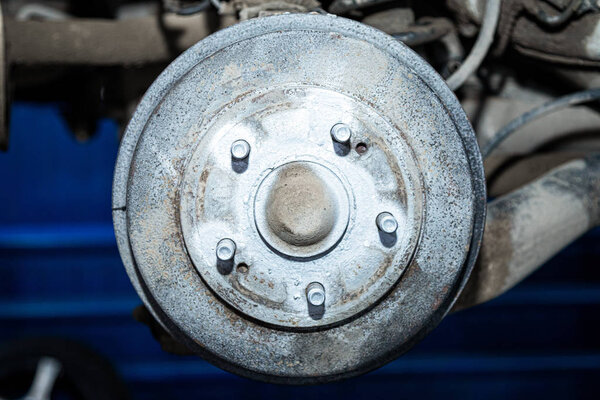Close-up of a car hub, drum brakes, brake pads, brake disc prepared for repair. Work at the tire workshop