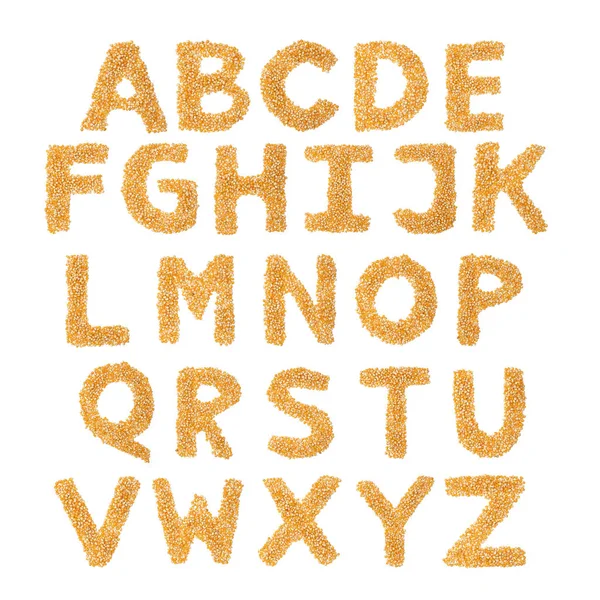 英语字母表来自黄色的干玉米 背景是白色孤立的 玉米制成的食物样式 商店的明亮字母表 玉米粥麦片 — 图库照片