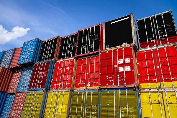 The national flag of Germany on a large number of metal containers for storing goods stacked in rows on top of each other. Conception of storage of goods by importers, exporters