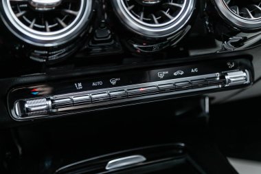 Novosibirsk, Russia  October 10, 2019:  Mercedes-Benz CLA-class, vehicle interior with visible climate controls, adjustment of the fragment of instrument panel.  clipart