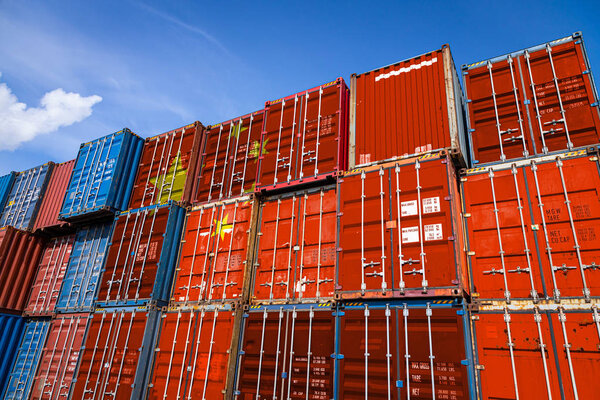 The national flag of China on a large number of metal containers for storing goods stacked in rows on top of each other. Conception of storage of goods by importers, exporters