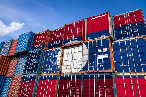 The national flag of Laos on a large number of metal containers for storing goods stacked in rows on top of each other. Conception of storage of goods by importers, exporters