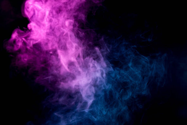 Smoke of pattern pink and blue in the form of horror monster on a dark isolated background. Scary and mysterious symbo