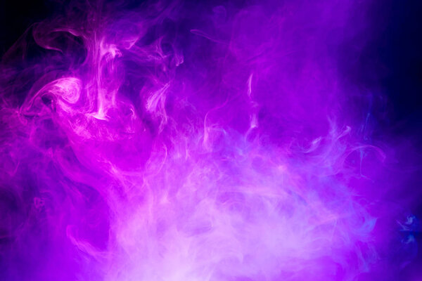 Transparent creativity. Abstract art colored pink smoke on black isolated background. Stop the movement of multicolored smoke on dark backgroun
