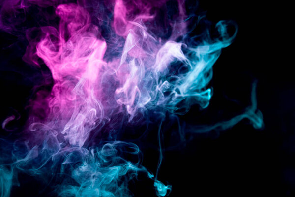 Close up of colorful pink and blue steam smoke in mystical and fabulous forms on black background.Mocap for art