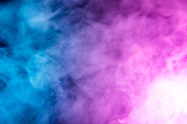 . Transparent creativity. Abstract art colored smoke on black isolated background. Stop the movement of multicolored smoke on dark backgroun