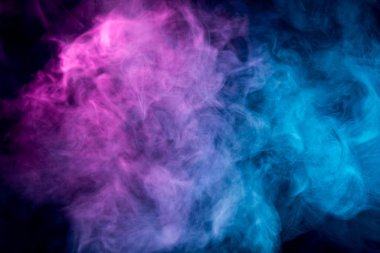. Transparent creativity. Abstract art colored smoke on black isolated background. Stop the movement of multicolored smoke on dark backgroun