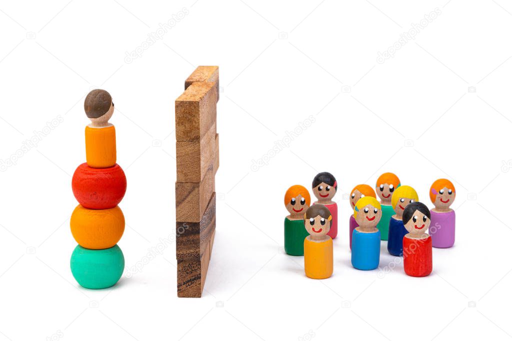 Wooden eco-toys, separated by a huge wall: on the one hand, one man is trying to get over, and on the other, a large crowd is waiting for his return. The concept of dividing people by the big wall