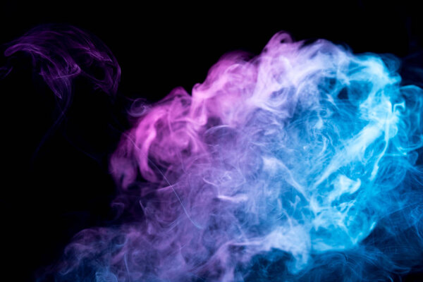 Frozen abstract movement of  explosion smoke multiple pink and blue  colors on black background. Background from the smoke of vap