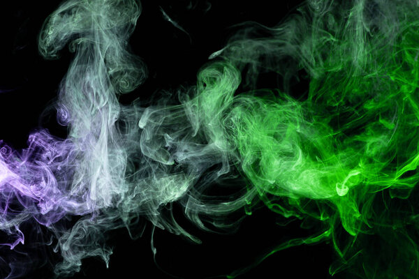 Frozen abstract movement of explosion smoke multiple blue and greencolors on black background. Background from the smoke of vap