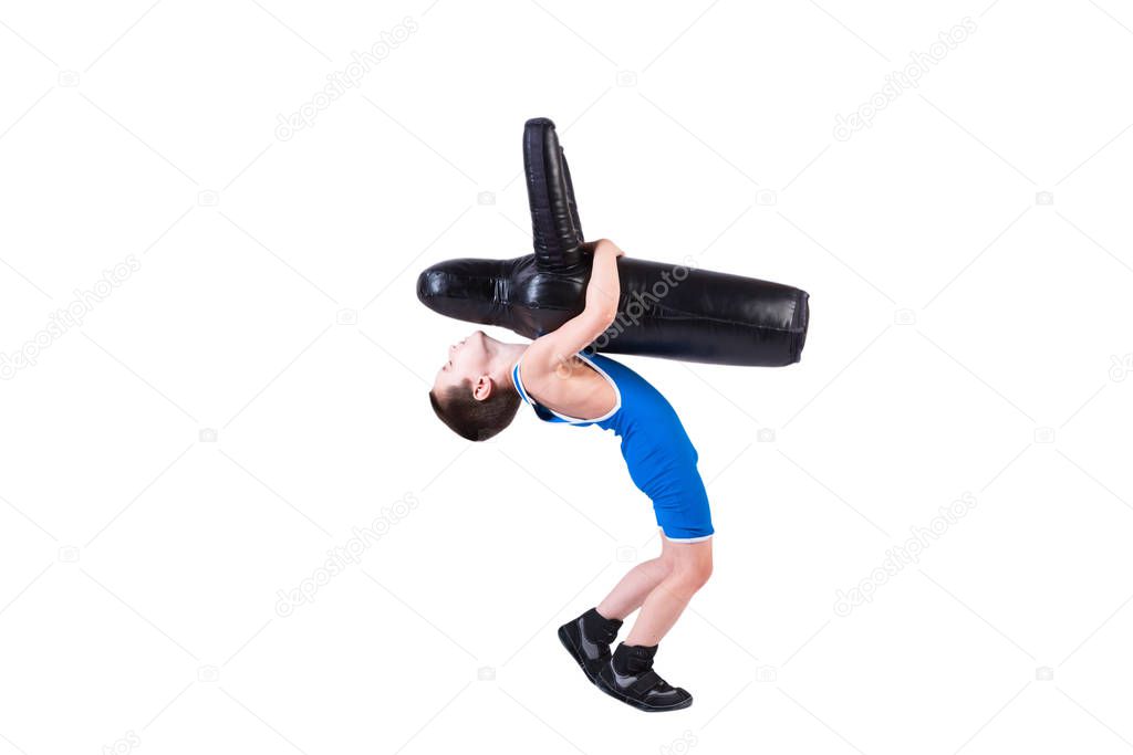 Cheerful sports boy in wrestling tights and wrestlers makes a throw through the back with a sporting dummy for training and handling techniques from various martial arts on a spruce isolated background. The concept of children's martial arts trainin