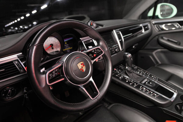 Novosibirsk, Russia  December 06, 2019:  Porsche Macan, luxury car Interior - steering wheel, shift lever, multimedia  systeme, driver seats and dashboard
