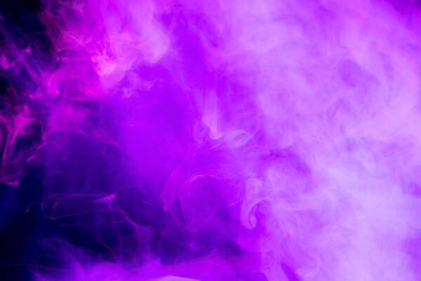 Fog colored with bright pink gel on dark background. Abstract artwork. Trendy wallpaper.