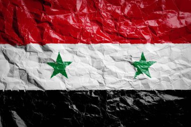 Suriye bayrağı buruşuk kağıt üzerinde. Çarşafa bayrak basılmış. Broşürlerde ve reklamlarda tasarım için bayrak resmi.