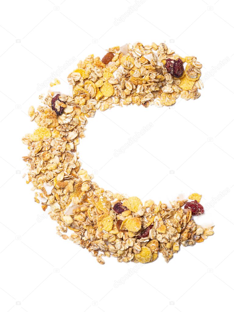Letter C of the English alphabet muesli with coconut, berries, raisins, cereal and natural cereals  on a white isolated background. Food pattern made from granola. bright alphabet for shops. 