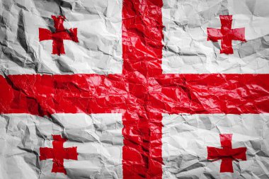 Gürcistan bayrağı buruşmuş kağıt üzerinde. Çarşafa bayrak basılmış. Broşürlerde ve reklamlarda tasarım için bayrak resmi.