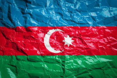 Azerbaycan bayrağı buruşmuş kağıtta. Çarşafa bayrak basılmış. Broşürlerde ve reklamlarda tasarım için bayrak resmi.