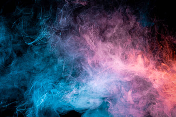  Red and  blue  cloud smoke on black  isolated background. Fog colored with bright pink gel on dark background