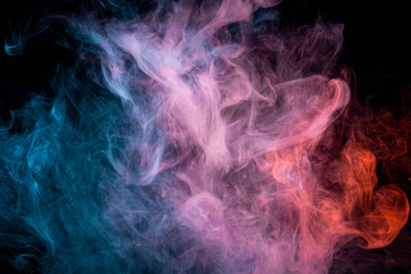  Red and  blue  cloud smoke on black  isolated background. Fog colored with bright pink gel on dark background