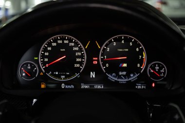 Novosibirsk, Russia  February 12, 2020: BMW X6, dashboard of the car is illuminated by bright illumination. Speedometer, circle tachometer, oil and fuel level
