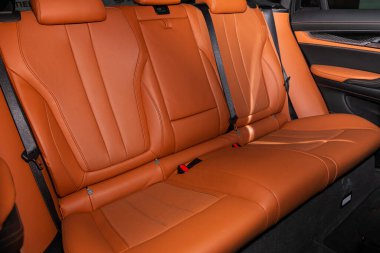 Novosibirsk, Russia  February 12, 2020: BMW X6, Rear seat for passengers in orange leather, open door to the passenger compartment