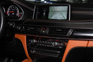 Novosibirsk, Russia  February 12, 2020: BMW X6, close-up of the central control panel, monitor with music and radio , adjustment of the blower, air conditioner, player. modern car interior