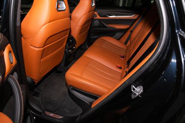 Novosibirsk, Russia  February 12, 2020: BMW X6, Rear seat for passengers in orange leather, open door to the passenger compartmen 