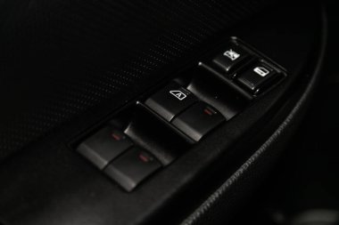 Novosibirsk, Russia  December 29, 2019:  Subaru Outback, close-up of the side door buttons: window adjustment buttons, door lock. modern car interior: parts, buttons, knob 