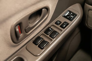 Novosibirsk, Russia  January 15, 2020:   Mitsubishi Montero Sport, close-up of the side door buttons: window adjustment buttons, door lock. modern car interior: parts, buttons, knob 