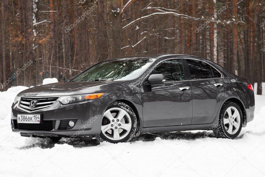 Novosibirsk, Russia  February 25, 2020:  black Honda Accord, front view.  Photography of a modern popular sedan  made in Japan standing on a snowy street in winter