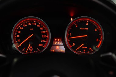 Novosibirsk, Russia  February 12, 2020:  BMW X6, dashboard of the car is illuminated by bright illumination. Speedometer, circle tachometer, oil and fuel level