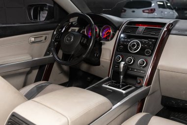 Novosibirsk, Russia  January 05, 2020:  Mazda CX-9, Dark luxury car Interior - steering wheel, dashboard, buttons for switching settings, gear lever and seats for passenger and driver
