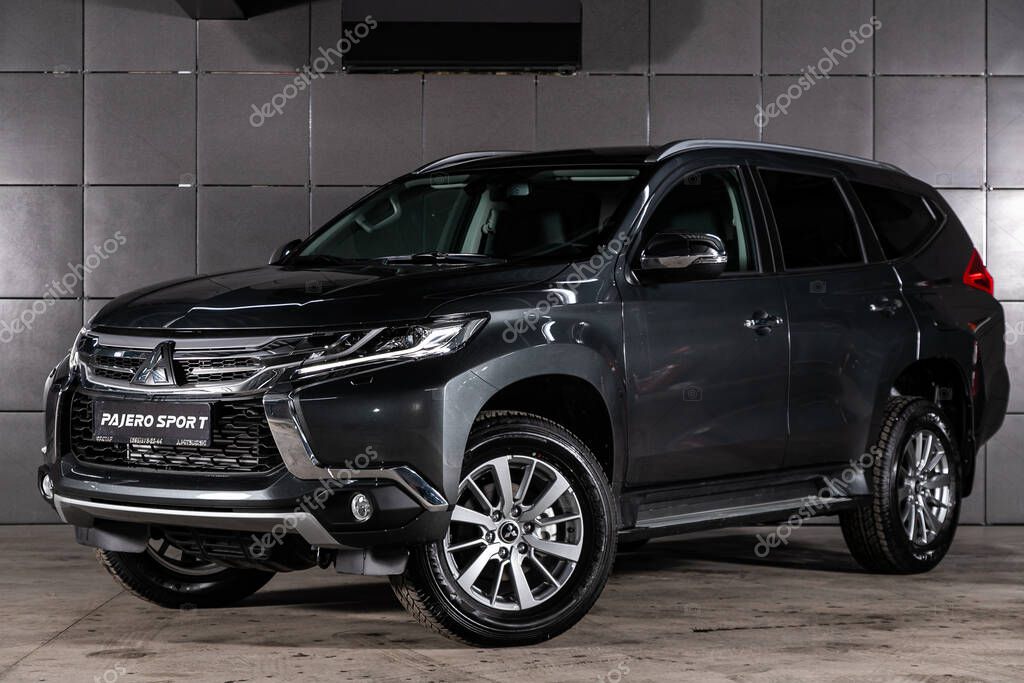 Novosibirsk, Russia  February 10, 2020: gray Mitsubishi Pajero Sport, front view.  New expensive  modern crossover made in Japan on a parking on black background