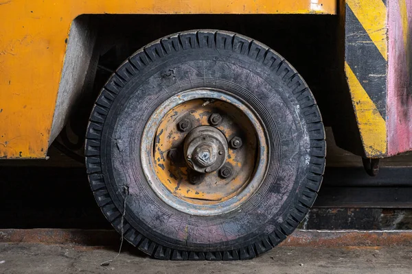Car wheel  on a old orange truck car closeup.